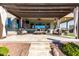 Large covered patio with seating and pergola at 42085 W Morning Glory Way, Maricopa, AZ 85138