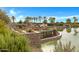 View of a community pond with lounge chairs and palm trees at 42085 W Morning Glory Way, Maricopa, AZ 85138