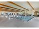 Indoor pool with exposed wooden beams and tall archways at 42085 W Morning Glory Way, Maricopa, AZ 85138