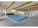 Indoor pool with exposed wooden beams and tall archways at 42085 W Morning Glory Way, Maricopa, AZ 85138