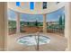 Relaxing hot tub area with decorative columns and serene mural backdrop at 42085 W Morning Glory Way, Maricopa, AZ 85138