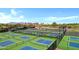 A high-angle view of well-maintained tennis courts, ideal for active residents seeking a vibrant lifestyle at 42085 W Morning Glory Way, Maricopa, AZ 85138