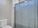 Simple bathroom with shower and striped curtain at 44622 N Sonoran Arroyo Ln, New River, AZ 85087