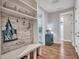 Inviting entryway with built-in bench, hooks, and shelving at 44622 N Sonoran Arroyo Ln, New River, AZ 85087