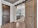 Entryway with barn door separating home office at 44622 N Sonoran Arroyo Ln, New River, AZ 85087