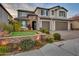 Two-story house with three-car garage, landscaping, and a welcoming front porch at 44622 N Sonoran Arroyo Ln, New River, AZ 85087