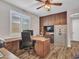 Home office features wood desk, safe, and built-in shelving at 44622 N Sonoran Arroyo Ln, New River, AZ 85087