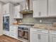 Modern kitchen with double ovens, gas cooktop, and herringbone backsplash at 44622 N Sonoran Arroyo Ln, New River, AZ 85087