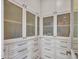 Bright walk-in pantry with white cabinets and frosted glass doors at 44622 N Sonoran Arroyo Ln, New River, AZ 85087