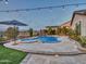 Inviting pool and spa with a waterfall, surrounded by a stone patio at 44622 N Sonoran Arroyo Ln, New River, AZ 85087