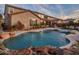 Luxury pool and spa with waterfall feature, surrounded by a beautifully landscaped backyard at 44622 N Sonoran Arroyo Ln, New River, AZ 85087