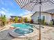 Relaxing pool and spa with a striped umbrella at 44622 N Sonoran Arroyo Ln, New River, AZ 85087