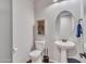 Powder room with pedestal sink and decorative shelving at 44622 N Sonoran Arroyo Ln, New River, AZ 85087