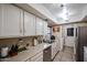 Clean and functional kitchen with white cabinets and updated sink at 4539 W Mclellan Rd, Glendale, AZ 85301