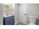 Simple bathroom with a navy vanity and a round mirror at 4565 N 26Th Dr, Phoenix, AZ 85017