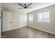 Bright bedroom with laminate flooring, ceiling fan, and double closets at 4565 N 26Th Dr, Phoenix, AZ 85017