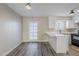 Modern white kitchen with quartz countertops and black appliances at 4565 N 26Th Dr, Phoenix, AZ 85017