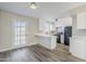 Modern kitchen with white cabinets, quartz countertops, and a breakfast bar at 4565 N 26Th Dr, Phoenix, AZ 85017