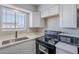 Newly remodeled kitchen with white cabinets and black appliances at 4565 N 26Th Dr, Phoenix, AZ 85017