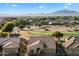 Luxury home with tile roof and attached garage, overlooking a golf course at 4655 E Indigo St, Gilbert, AZ 85298