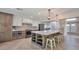 Open concept kitchen with island and white cabinets at 4818 E Dartmouth Cir, Mesa, AZ 85205