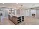 Modern kitchen with large island, white cabinets, and herringbone floors at 4818 E Dartmouth Cir, Mesa, AZ 85205