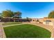 Spacious backyard with artificial turf, a pergola, and a built-in grill at 494 S 220Th Ln, Buckeye, AZ 85326