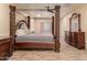 Main bedroom with a four-poster bed and plenty of natural light at 494 S 220Th Ln, Buckeye, AZ 85326