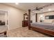 Spacious bedroom with a large bed, dresser, and ceiling fan at 494 S 220Th Ln, Buckeye, AZ 85326