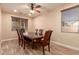 Formal dining room with a large wood table and six leather chairs at 494 S 220Th Ln, Buckeye, AZ 85326