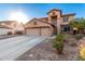 Two-story house with a three-car garage and partial landscaping at 494 S 220Th Ln, Buckeye, AZ 85326