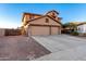 Two-story house with a three-car garage and desert landscaping at 494 S 220Th Ln, Buckeye, AZ 85326