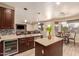 Open kitchen with large island, granite countertops, and breakfast bar at 494 S 220Th Ln, Buckeye, AZ 85326