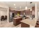 Spacious kitchen boasts granite countertops and dark wood cabinets at 494 S 220Th Ln, Buckeye, AZ 85326