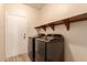 Laundry room with washer, dryer, and shelving at 494 S 220Th Ln, Buckeye, AZ 85326