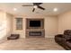 Living room with a modern fireplace and brown leather sectional at 494 S 220Th Ln, Buckeye, AZ 85326