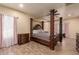 Main bedroom with four-poster bed and wood flooring at 494 S 220Th Ln, Buckeye, AZ 85326