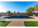 Inviting pool with a waterfall feature and plenty of lounge space at 494 S 220Th Ln, Buckeye, AZ 85326