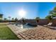 Relaxing kidney-shaped pool with a waterfall feature and lounge chairs at 494 S 220Th Ln, Buckeye, AZ 85326