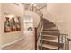 Elegant curved staircase with decorative railing and unique flooring at 494 S 220Th Ln, Buckeye, AZ 85326