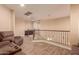 Upstairs hallway with wood-look flooring and wrought-iron railing at 494 S 220Th Ln, Buckeye, AZ 85326