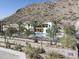 Aerial view of community pool and building with mountain backdrop at 5000 E Camelback Ridge Rd # 301, Scottsdale, AZ 85251