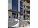 Condo building entrance with stone facade, modern doors, and landscaping at 5000 E Camelback Ridge Rd # 301, Scottsdale, AZ 85251