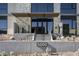 Modern condo building entrance with stone and glass accents at 5000 E Camelback Ridge Rd # 301, Scottsdale, AZ 85251