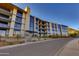 Modern apartment building featuring balconies, large windows, and stone accents at 5000 N Camelback Ridge Dr # 301, Scottsdale, AZ 85251