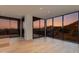 Bright open-concept living room with hardwood floors and floor-to-ceiling windows at 5000 N Camelback Ridge Dr # 301, Scottsdale, AZ 85251