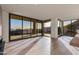 Bright living room with hardwood floors and floor-to-ceiling windows offering scenic city views at 5000 N Camelback Ridge Dr # 301, Scottsdale, AZ 85251