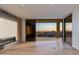 Bright living room features a fireplace and large sliding glass doors to a private balcony with city views at 5000 N Camelback Ridge Dr # 301, Scottsdale, AZ 85251