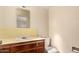 Retro bathroom with yellow tiled walls and wood vanity at 5331 E Virginia Ave, Phoenix, AZ 85008