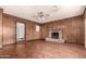 Living room with brick fireplace and wood floors at 5331 E Virginia Ave, Phoenix, AZ 85008